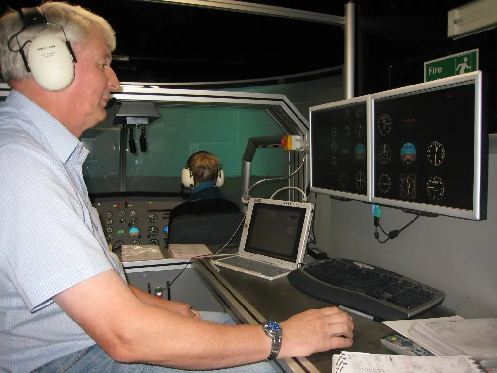 Instructor running a session on the FNPT II helicopter simulator